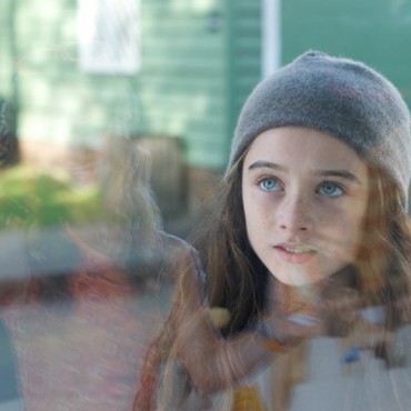 Molly stares at Qube ad - still from the movie