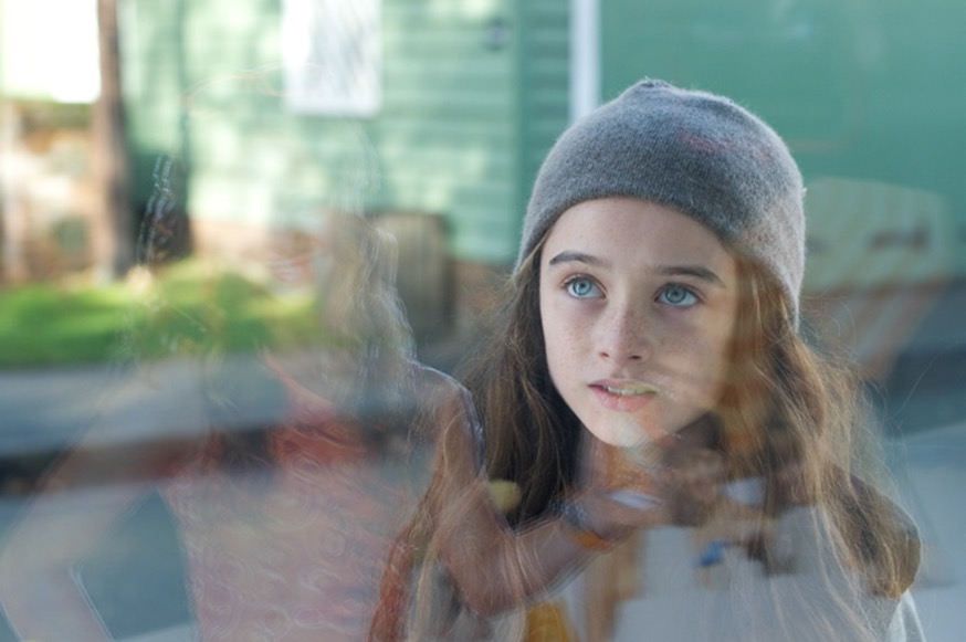 Molly stares at Qube ad - still from the movie